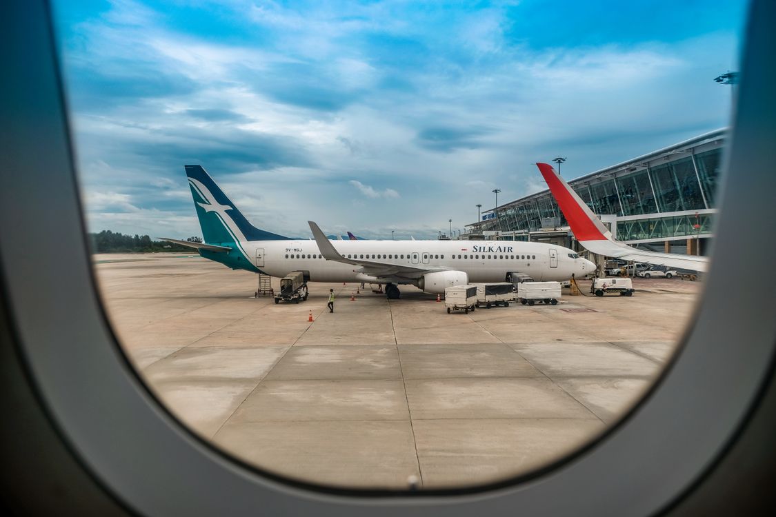 View of planes from an airplane window on the runway
