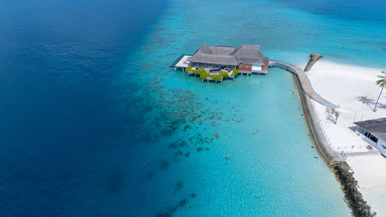 Aerial view of a Maldives resort and turquoise lagoon
